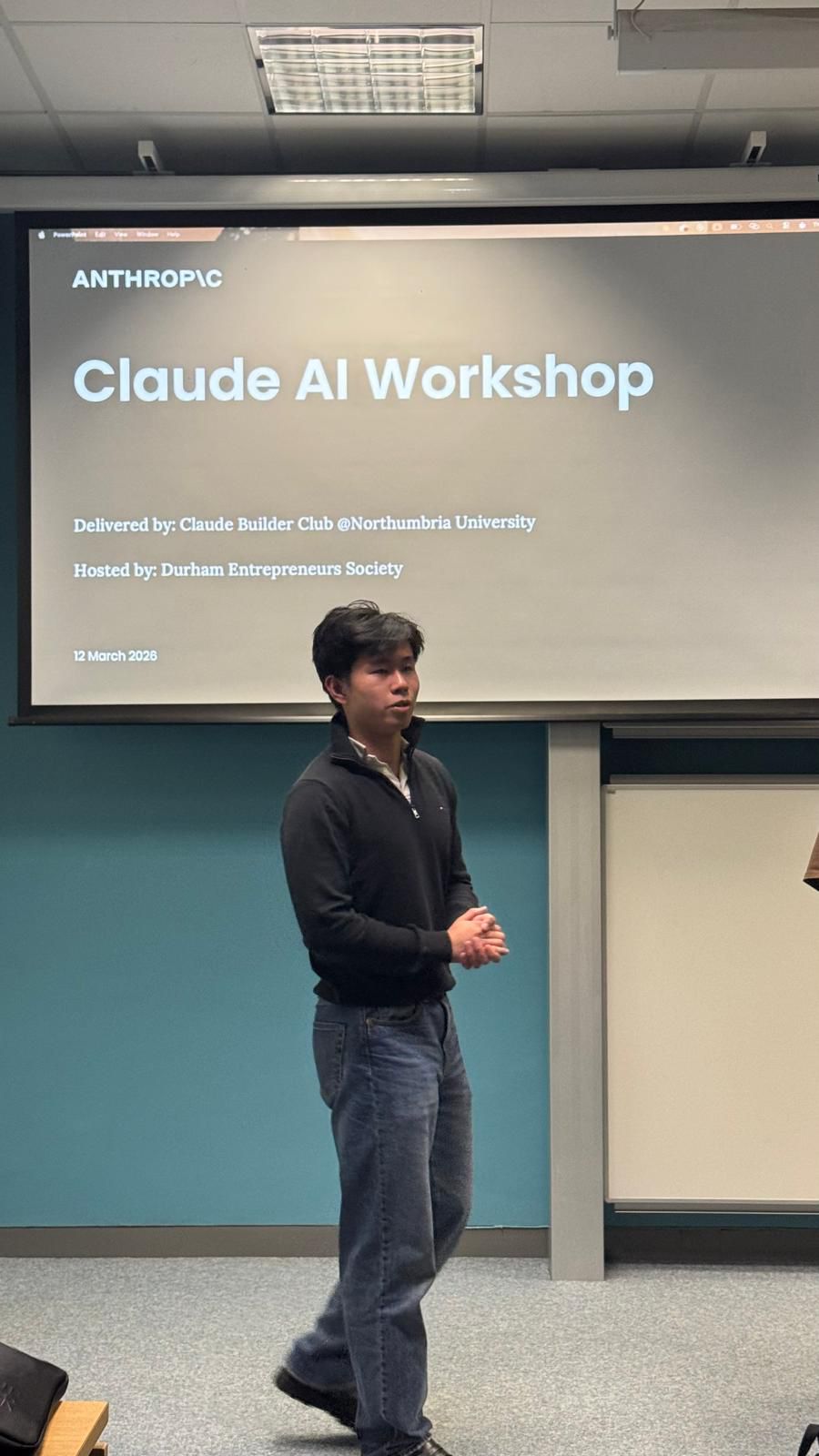Presenter in front of the Claude AI Workshop title slide.