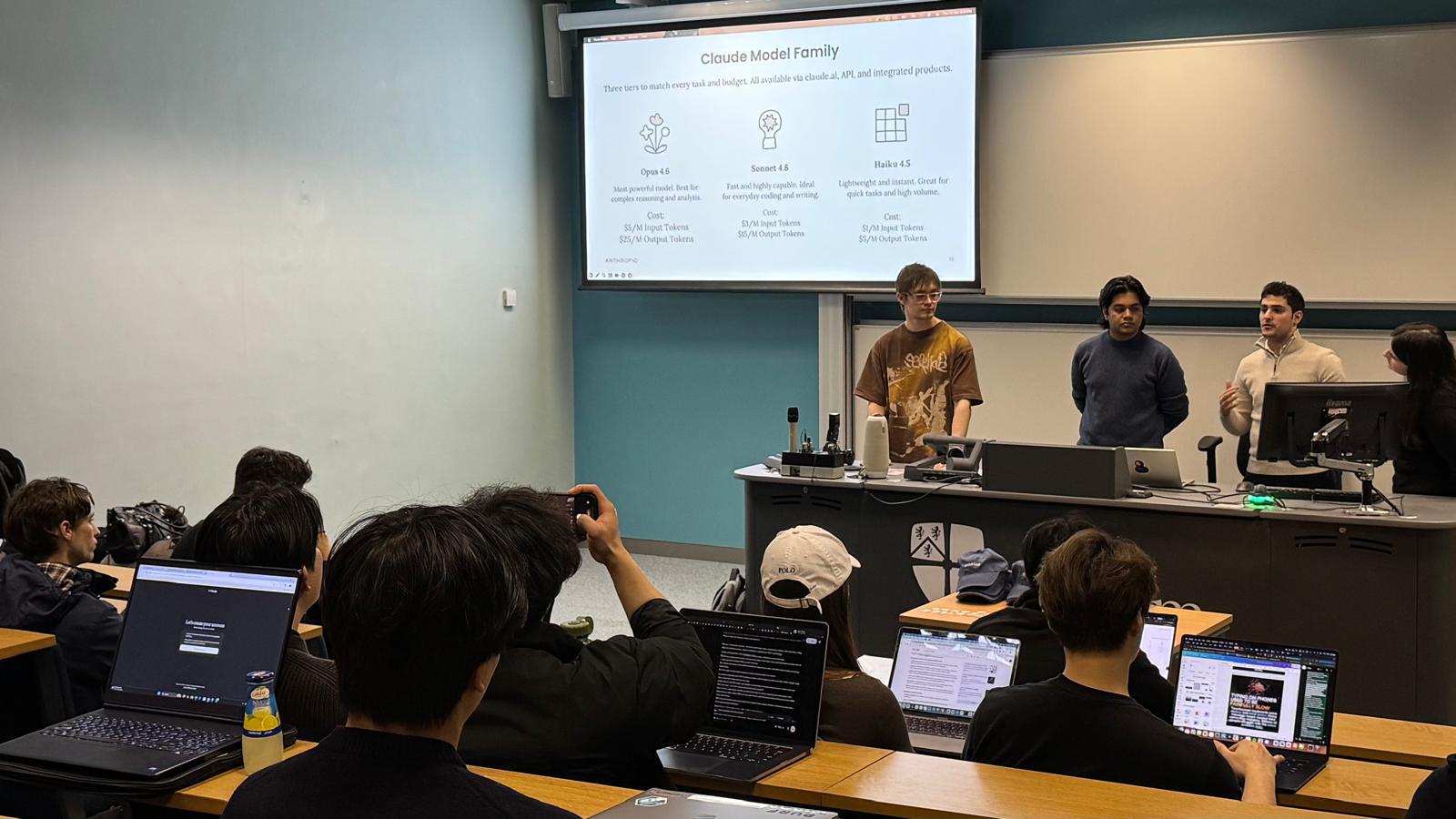 Presenters introducing Claude to attendees in a Durham lecture room.