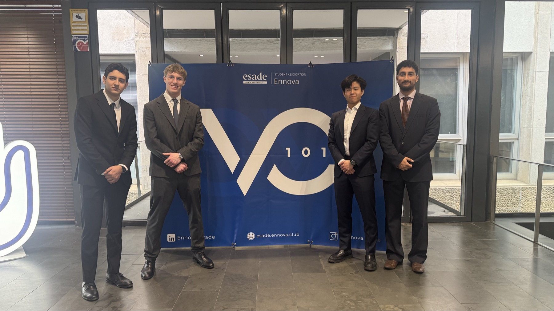 Four attendees standing in front of the VC101 and Esade Ennova backdrop.